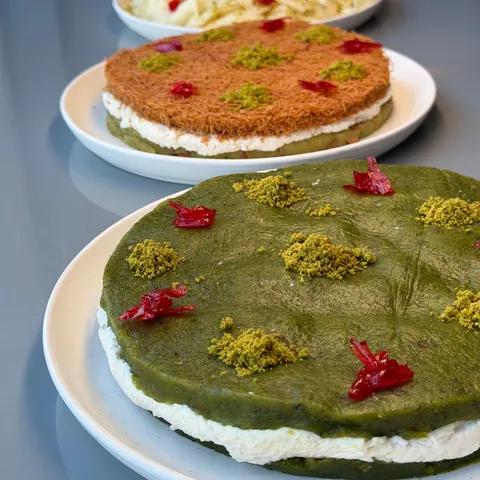Pistachio kunafa cakes lined up on the counter