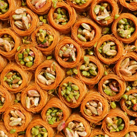 A tray of bird’s nest baklava with whole pistachios