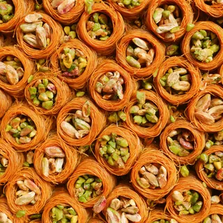 Rows of golden kataifi nests filled with pistachios