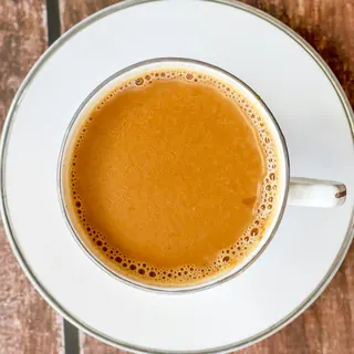 A cup of frothy teh tarik seen from above