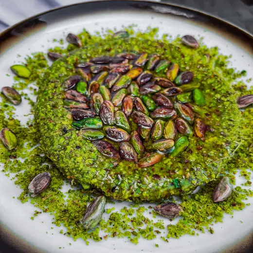 Pistachio kunafa covered in ground and whole pistachios