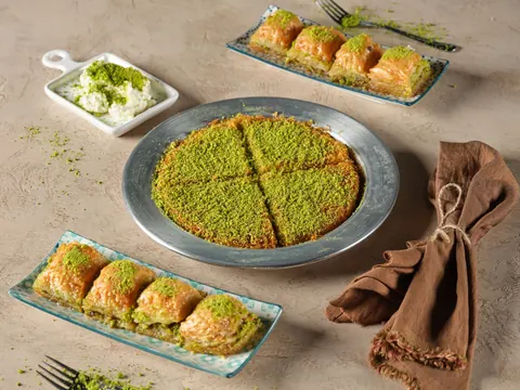 Pistachio kunafa and baklava laid out for sharing